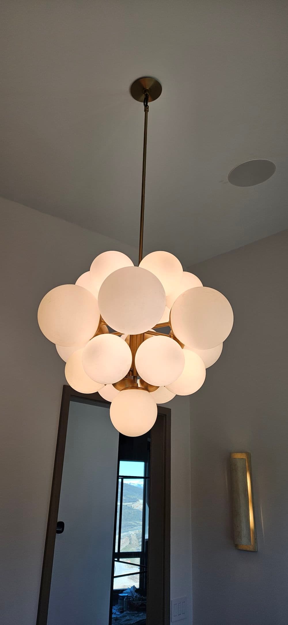 Modern chandelier with multiple glass orbs, adding elegance to a stylish interior space.