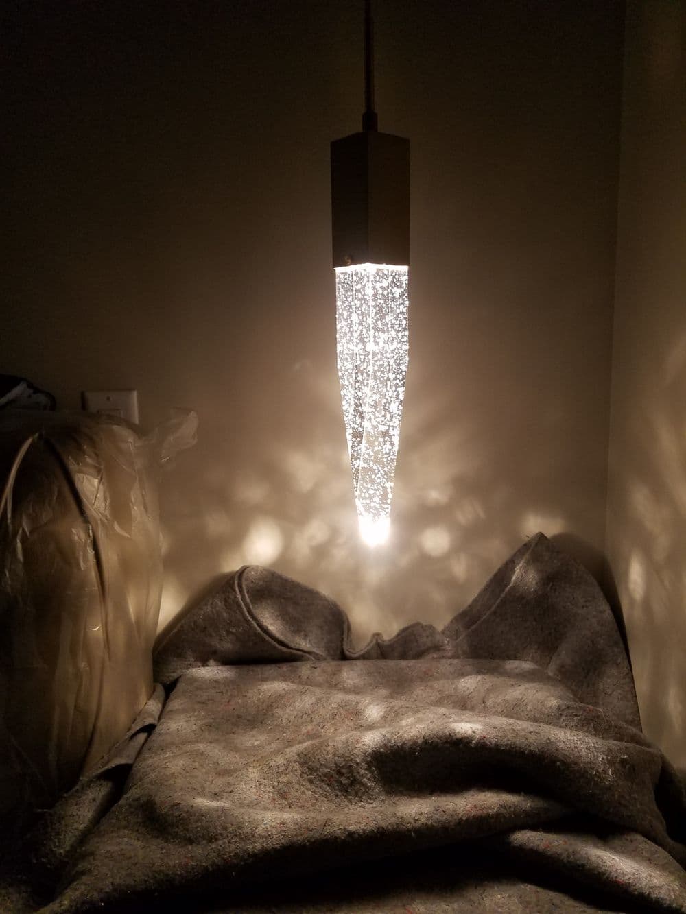 Modern pendant light with a sparkling design illuminating a cozy interior setting.